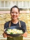 Vietnamese happy waitress holging Caesar salad