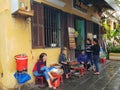 Vietnamese ladies chat in front of local food shop in Hoi an ancient street town in Vietnam.