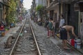 Vietnamese locals enjoy their life by the tracks in a tiny street of Ha Noi, Viet Nam Royalty Free Stock Photo