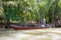 Vietnamese with long boats waiting for tourist to give them a ride on Mekong rive, Vietnam