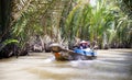 Vietnamese with long boats waiting for tourist to give them a ride on Mekong rive, Vietnam