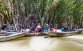 Vietnamese with long boats waiting for tourist to give them a ride on Mekong rive, Vietnam