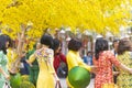 Vietnamese lunar new year. Women wear Vietnam tradition ao dai to take pictures on street with yellow flower apricot in Tet Royalty Free Stock Photo