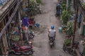 Vietnamese man rides his vintage moped in the old alley of Hao Si Phuong in Ho Chi Minh City Royalty Free Stock Photo