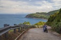 Vietnamese man rides in the mountains near the sea on a maotbike Royalty Free Stock Photo