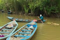 Vietnamese man rowing on a boat along one of the tributaries of Mekong River near My Tho, Vietnam.