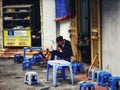 Vietnamese man sitting on small blue plastic chair at a Hanoi coffee shop I& x27;m Vietnam