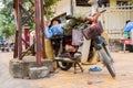 Vietnamese man sleeps on motorbike on street in My Tho, Vietnam