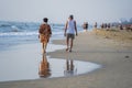 Vietnamese man and woman relax on the beach near sea in the morning before sunrise on the city Da nang, Vietnam