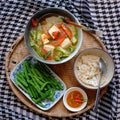 Vegan food menu with boiled peas, bowl of okra, tomato, tofu soup and rice