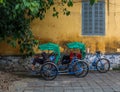 Vietnamese men taking a nap on a vintage touristic bike during work