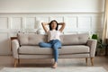 Vietnamese millennial girl rest on comfortable couch at home Royalty Free Stock Photo