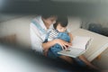 Vietnamese mother and little daughter girl reading a book in the Royalty Free Stock Photo