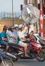 Vietnamese motorcyclist drives electric fan