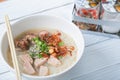 Vietnamese noodle soup on white wooden table.