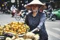 Vietnamese woman with bike selling fruit in the city street Royalty Free Stock Photo