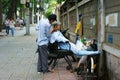 Vietnamese open air barber shop on pavement Royalty Free Stock Photo