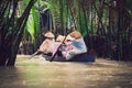 Vietnamese people on a small wooden vessel. Mekong river.