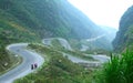 Vietnamese people walking on a long mountain road