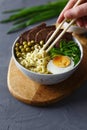 Vietnamese Pho Bo soup in bowl. Beef pho bo with eggs and green peas.