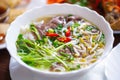 Vietnamese pho bo soup with red hot pepper and spice mixed with boiled beef meat,sprouted beans.Delicious pho broth served in Royalty Free Stock Photo