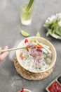 Vietnamese Pho Noodle Soup. Beef with Chilli, Basil, Rice Noodles, Bean Shoots showing noodles picked up with Chopsticks Royalty Free Stock Photo