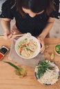 Vietnamese Pho Noodle Soup. Beef with Chilli, Basil, Rice Noodles, Bean Shoots showing noodles picked up with Chopsticks Royalty Free Stock Photo
