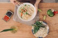 Vietnamese Pho Noodle Soup. Beef with Chilli, Basil, Rice Noodles, Bean Shoots showing noodles picked up with Chopsticks Royalty Free Stock Photo