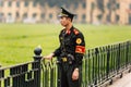 Vietnamese police officer standing on the green field in front of Ho Chi Minh Mausoleum at Hanoi, Vietnam