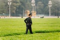 Vietnamese police officers walking on the green field in front of Ho Chi Minh Mausoleum at Hanoi, Vietnam