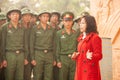 Vietnamese professor woman lecturing to young vietnamese soldier at statue of the French General De Castries