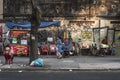 Vietnamese residents enjoy a quiet moment on the street by an old wall in Ho Chi Minh City, Vietnam