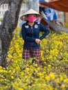 Vietnamese seller at flower market on Tet, Vietnam