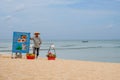 Vietnamese seller of fruits in traditional vietnamese `non la` hat on the Long Beach - the most famous beach on Phu Quoc island