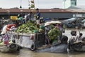 Vietnamese sellers on a boat with vegetables in a floating market on the Mekong river in Vietnam