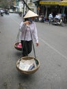 Vietnamese shop assistant assistant going along streets looking for the buyer