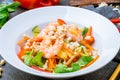 Vietnamese shrimp salad with vegetables on dark stone table