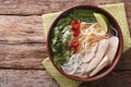 Vietnamese soup Pho Ga with chicken and rice noodles, bean sprouts close-up. horizontal top view