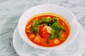 Vietnamese spicy tom yam soup on a marble table