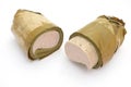 Vietnamese steamed pork sausage wrapped under banana leaf, two half roll Royalty Free Stock Photo
