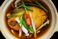 Vietnamese stewed sapa fish in bouillon isolated on black bacground top view