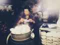 Vietnamese street food vendor at night outdoor market.