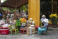 Vietnamese street vendor sells local food on the street in Hoi An, Vietnam Royalty Free Stock Photo