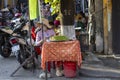 Vietnamese street vendor sells local food on the street in Hoi An, Vietnam Royalty Free Stock Photo