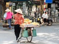 Vietnamese street vendors act and sell their vegetables and fruit products in Hanoi, Vietnam Royalty Free Stock Photo