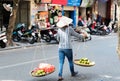 Vietnamese street vendors act and sell their vegetables and fruit products in Hanoi, Vietnam Royalty Free Stock Photo