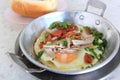 Vietnamese style fried egg in pan with white pork sausage