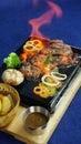 Vietnamese traditional grilled beefsteak on a hot stone. Royalty Free Stock Photo