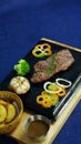 Vietnamese traditional grilled beefsteak on a hot stone. Royalty Free Stock Photo