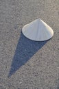 Vietnamese traditional leaf hat with shadow on the hot road surf